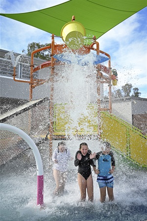 Splash-Park-with-bucket-tipping-with-children-portrait-hero.jpg