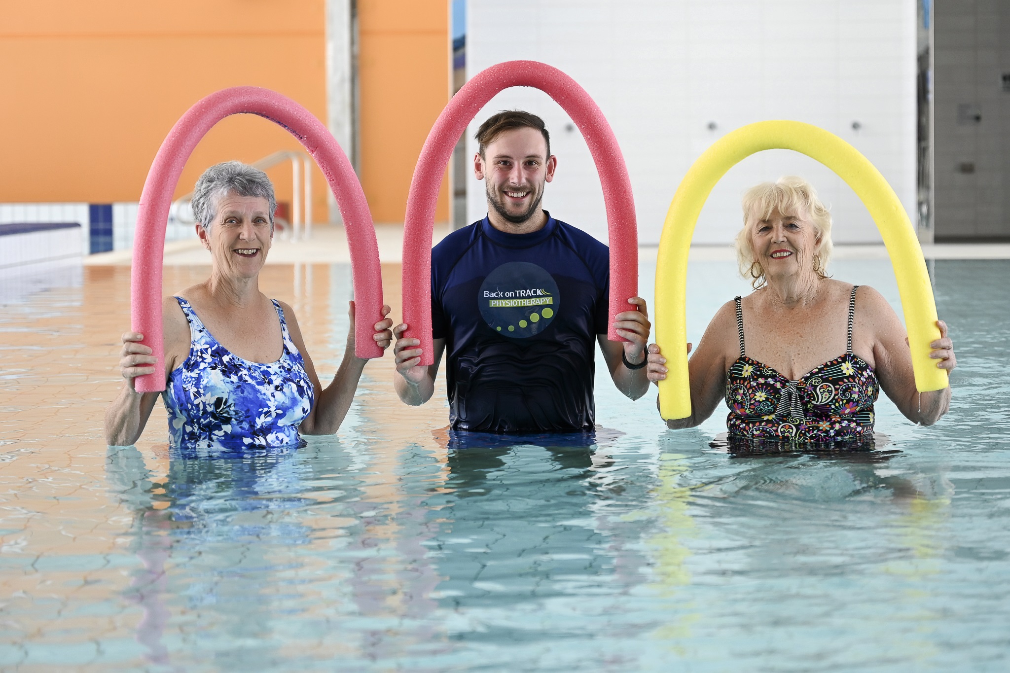 25m-pool-physiotherapy-with-noodles-over-head-smiling.jpg